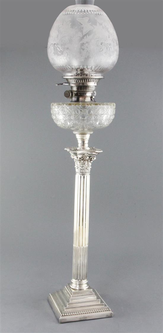 A late Victorian silver corinthian column oil lamp by Walker & Hall, overall height 87cm.